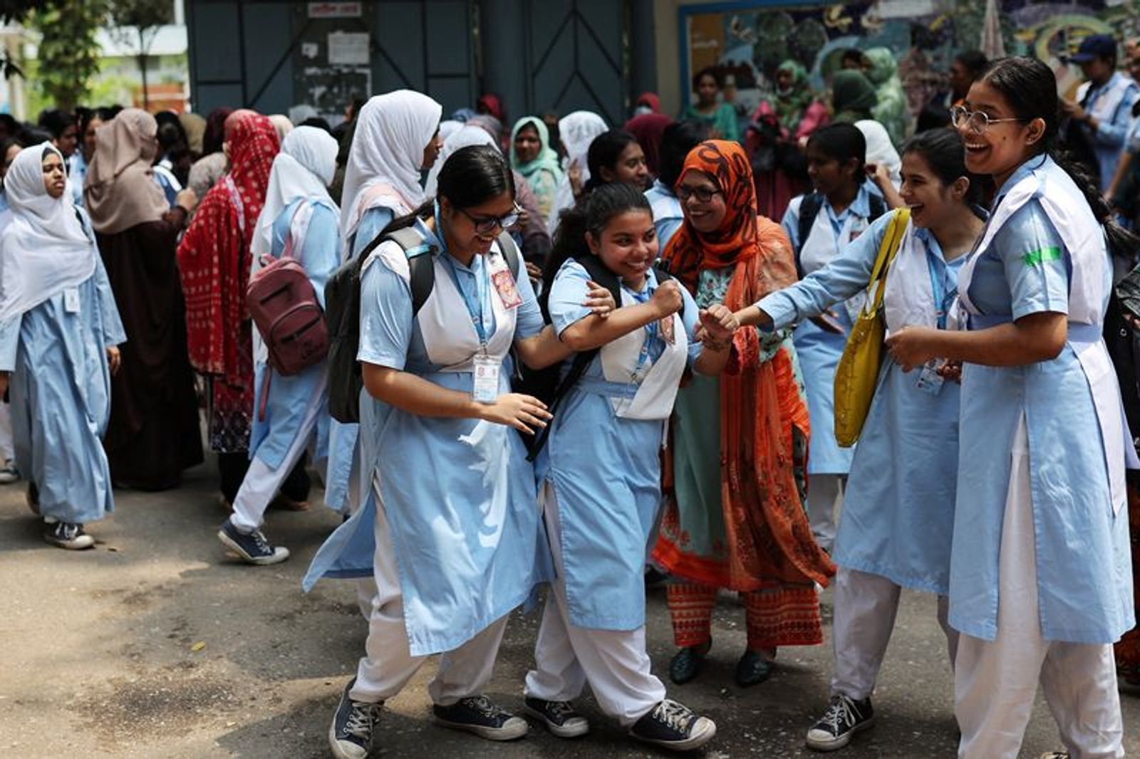Students laugh as schools reopen after the fall in temperature, in Dhaka, Bangladesh, May 5, 2024. REUTERS/Mohammad Ponir Hossain