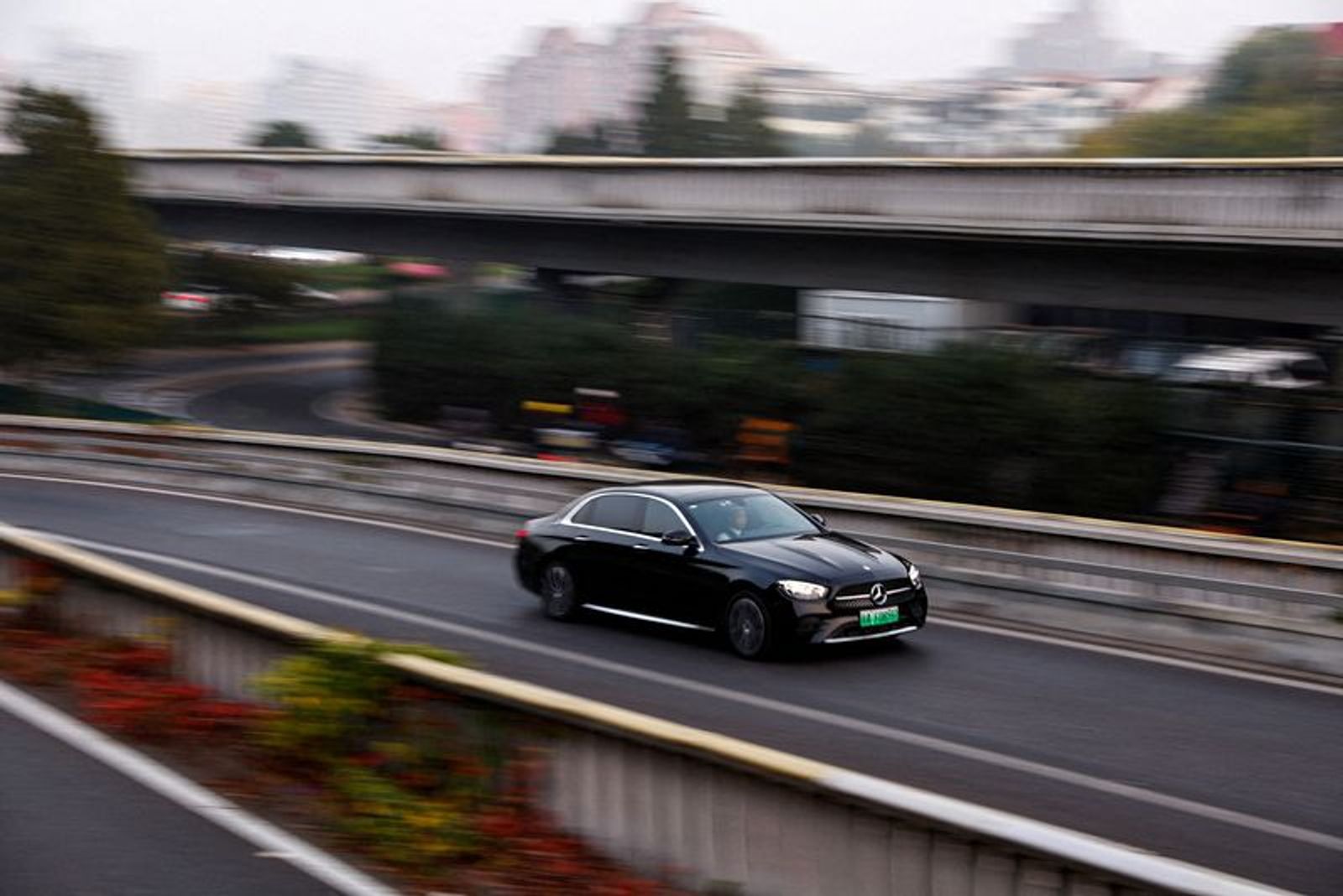 FILE PHOTO: An electric vehicle (EV) by Mercedes-Benz moves on a street in Beijing, China October 31, 2023. REUTERS/Tingshu Wang/File Photo