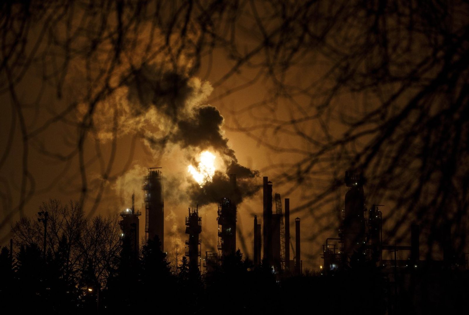 A flare stack lights the sky from an oil refinery in Edmonton on Friday December 28, 2018. Executives of some of Canada's largest oil and gas companies are expected to testify before a parliamentary committee Thursday about their efforts to reduce their sector's greenhouse gas emissions.  THE CANADIAN PRESS/Jason Frans