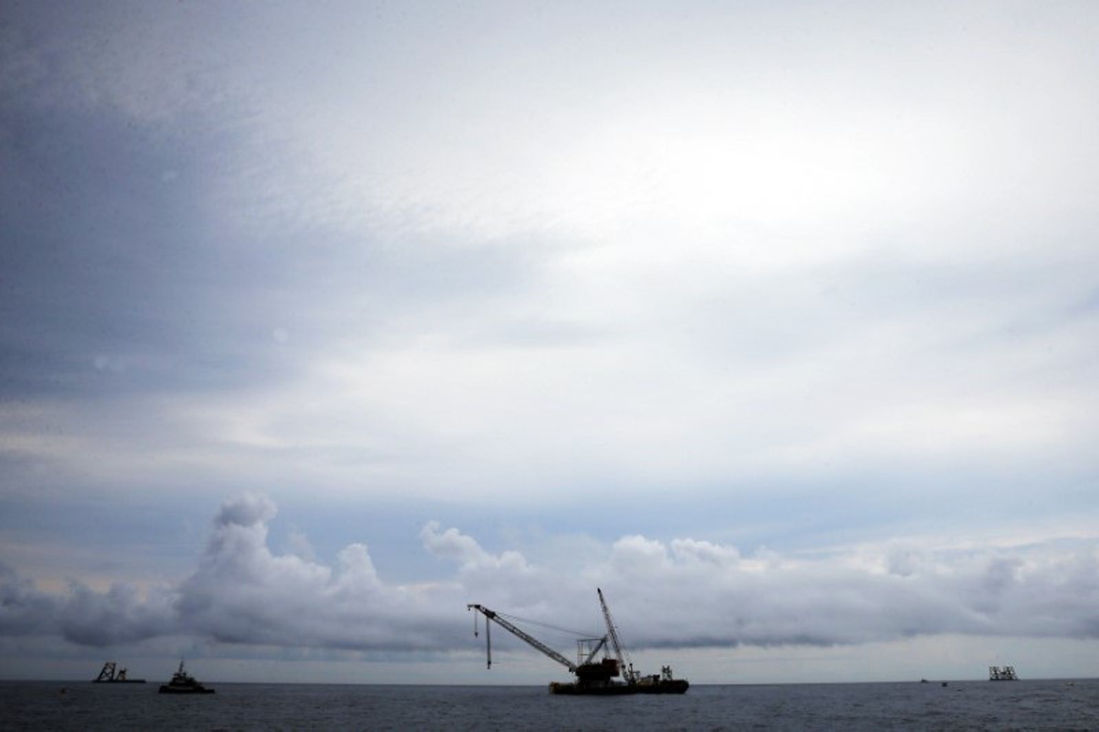 FILE PHOTO: A construction barge and crane float next to the first jacket (C) installed to support a turbine for a wind farm in the waters of the Atlantic Ocean off Block Island, Rhode Island July 27, 2015. REUTERS/Brian Snyder/File Photo