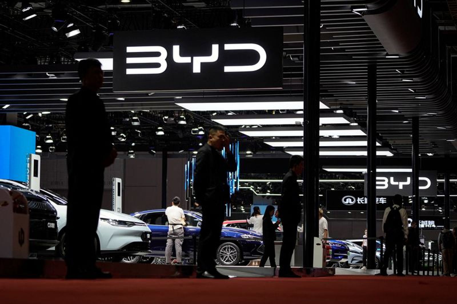 FILE PHOTO: Security guards stand at the BYD booth at the Auto Shanghai show, in Shanghai, China April 19, 2023. REUTERS/Aly Song/File Photo