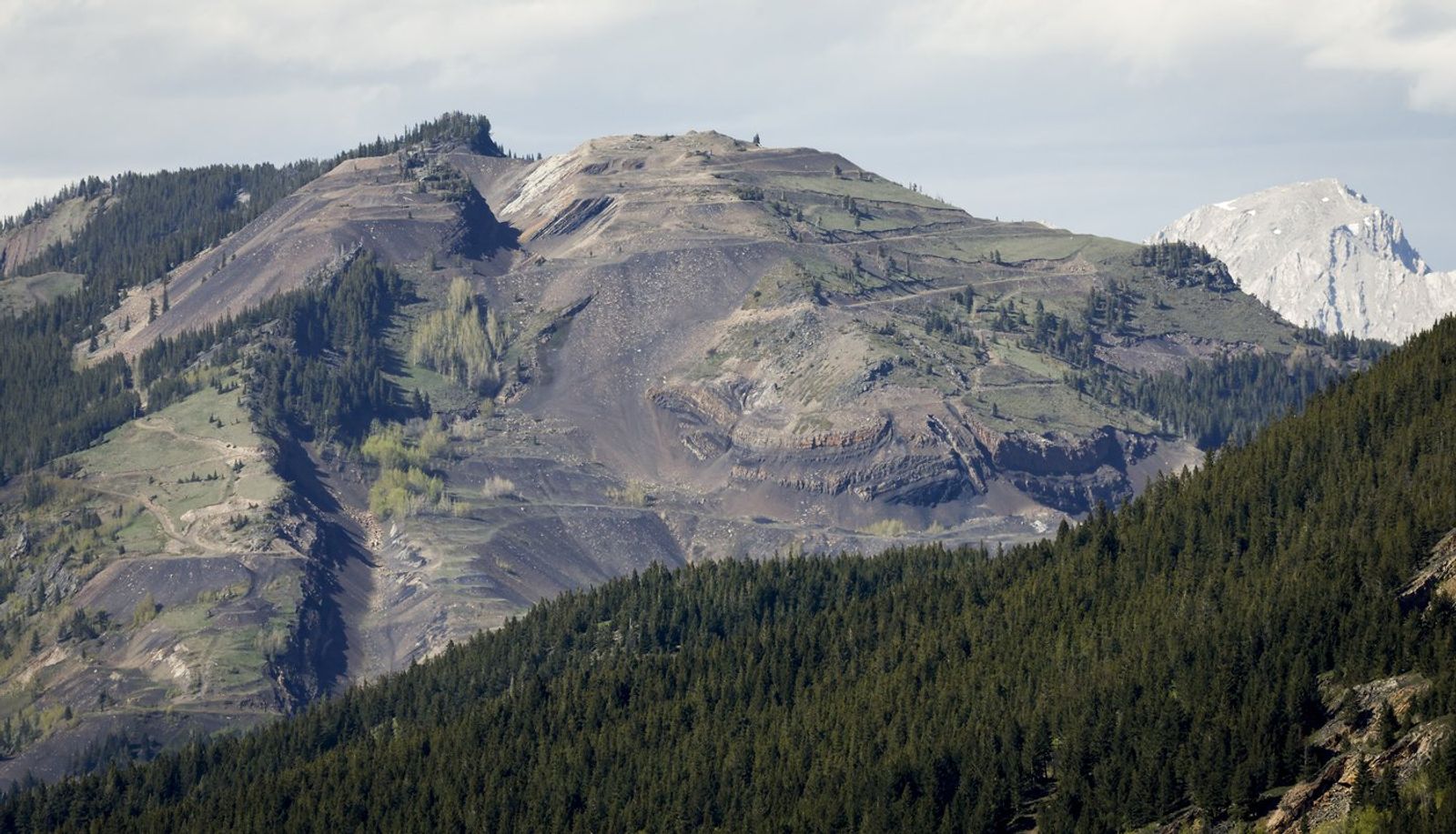 Grassy Mountain, peak on left, and the Grassy Mountain Coal Project are seen north of Blairmore, Alta., Thursday, June 6, 2024. At least two groups are asking Alberta's energy regulator to call off hearings on coal exploration in the Rocky Mountains while the province's top court rules on whether the applications are valid.THE CANADIAN PRESS/Jeff McIntosh