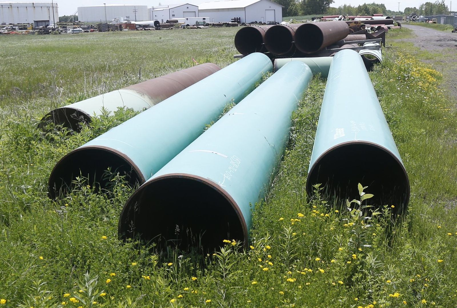 FILE - Pipeline used to carry crude oil sits at the Superior, Wis., terminal of Enbridge Energy, June 29, 2018. (AP Photo/Jim Mone, File)